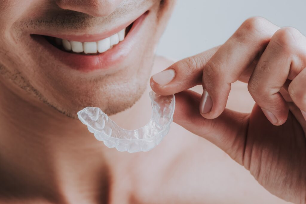 Close-up of a customized dental mouthguard resting on a surface, designed to fit over teeth for protection during sports or at night.