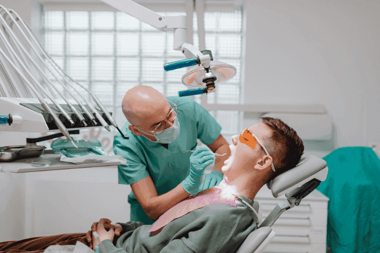 Dentist performing a routine dental examination on a patient in a modern dental clinic.