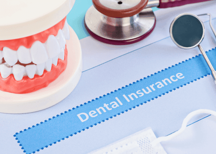 Dental insurance coverage illustration with teeth model and medical instruments.